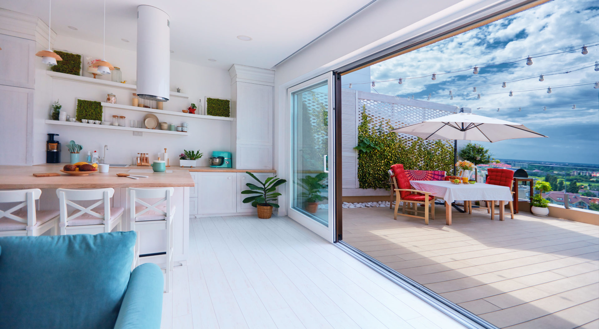 A modern white kitchen that opens into a dining room